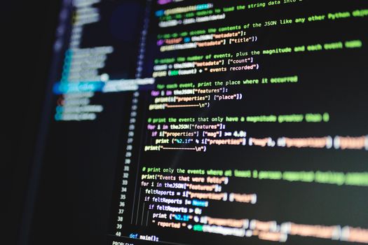 Home Close-up of colorful programming code displayed on a computer monitor with a dark background.